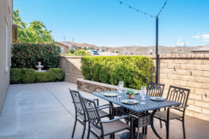Outdoor patio with dining area and mountain views, ideal for low-maintenance living when downsizing in Santa Clarita