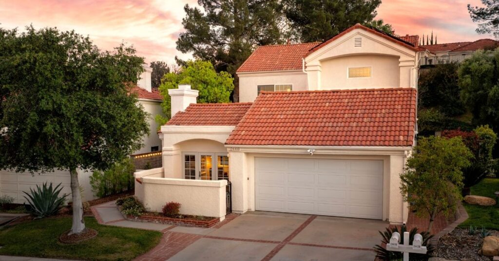 Exterior front-facing photo of a five bedroom home at dusk in the Valencia Summit