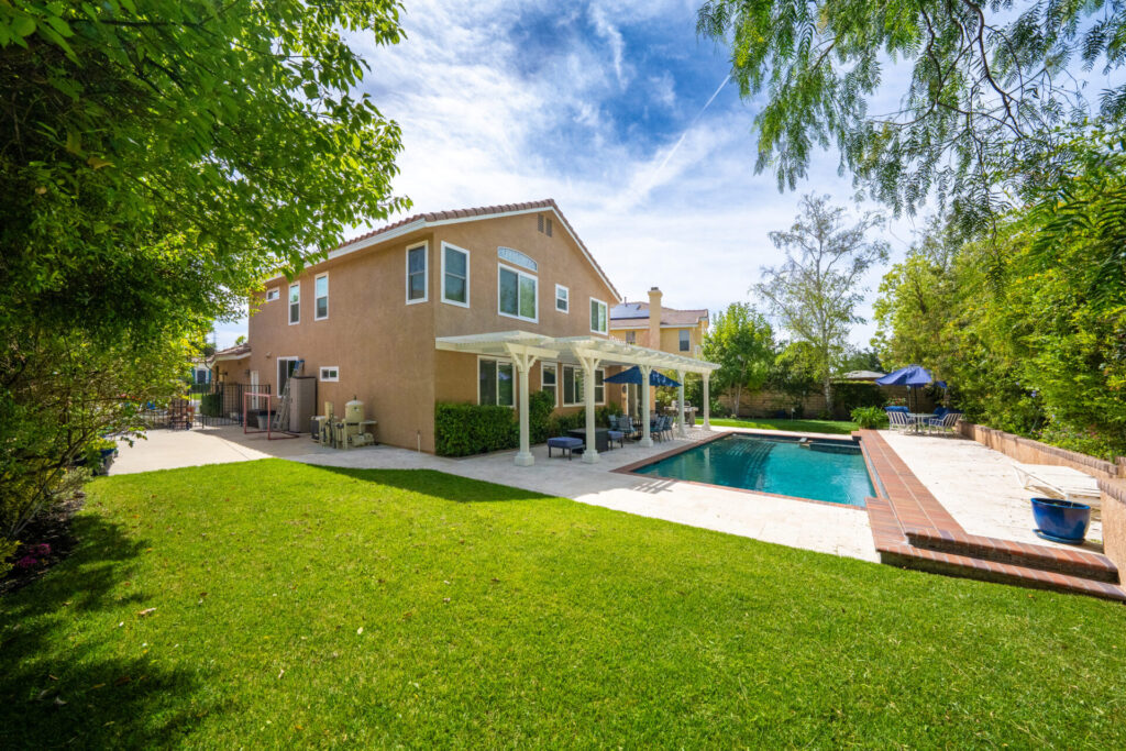 backyard featuring a large grassy area and pool