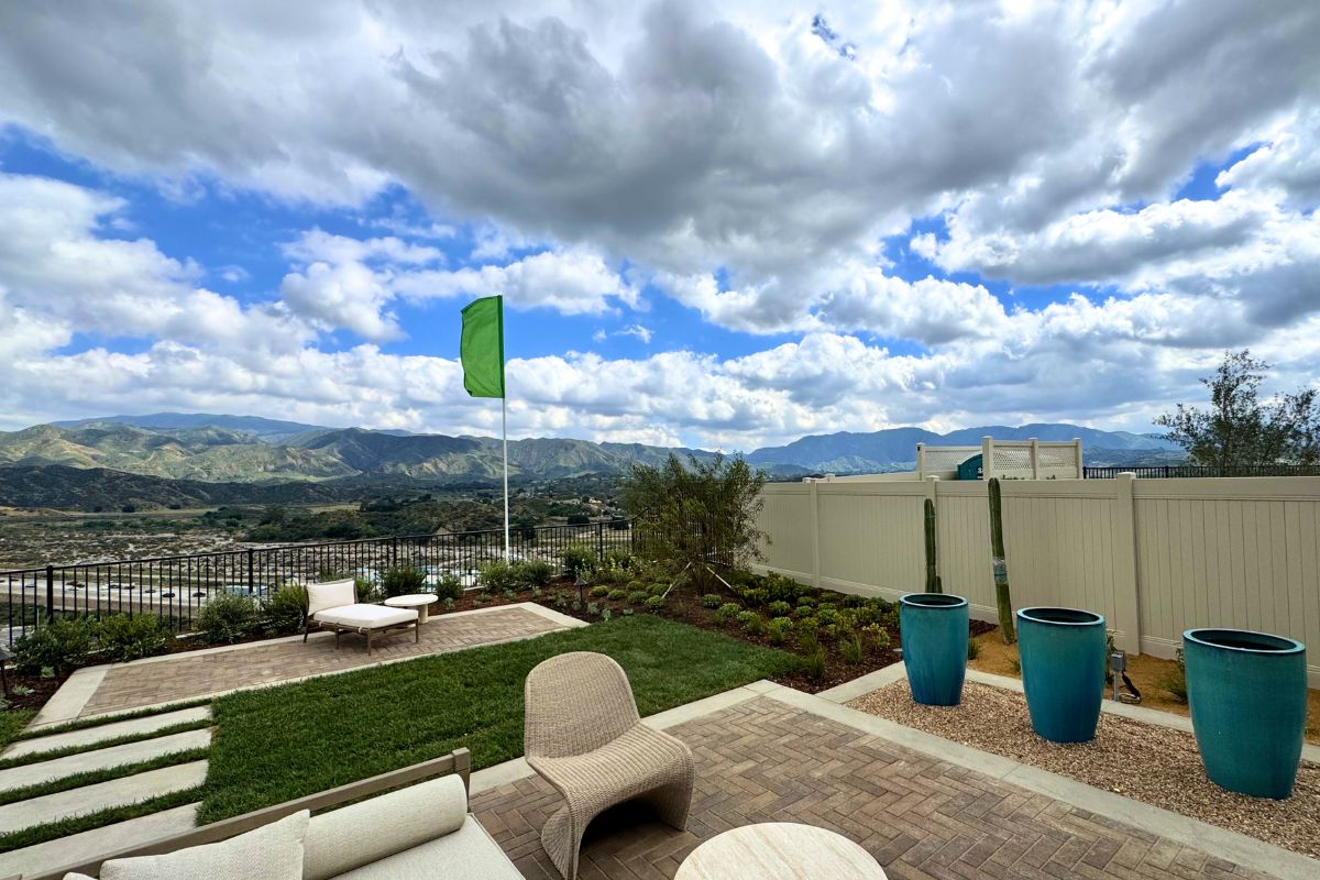 View of mountains and cloudy skies from a backyard in the Pelona Hills community
