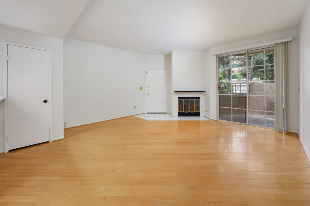 living room with a large sliding glass door to the patio, a fireplace, and entry way