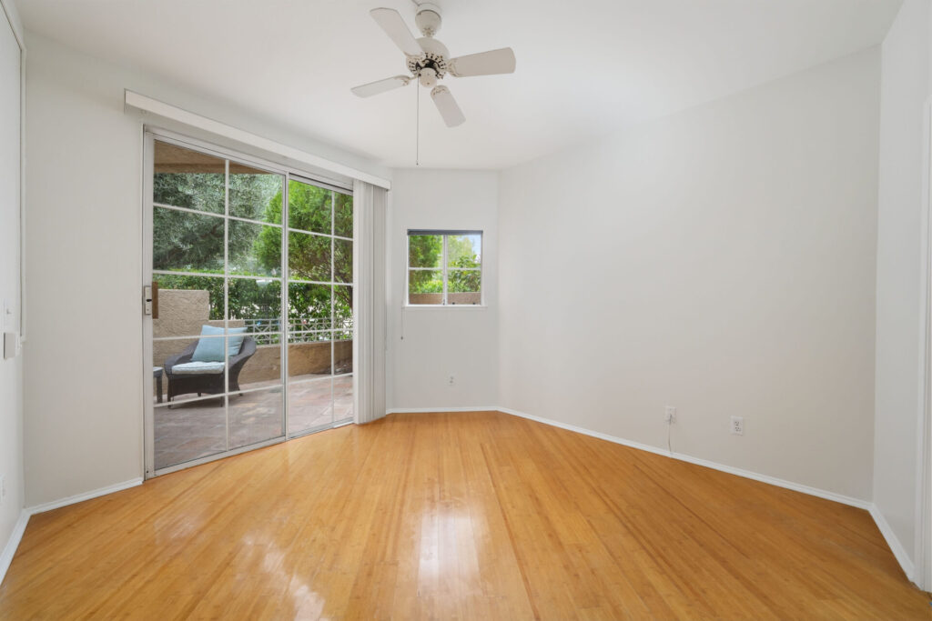 Primary bedroom with a sliding glass door to the patio